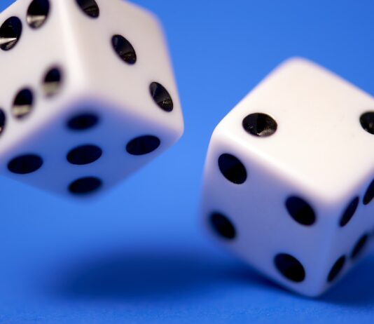 2 white dices on blue surface