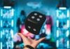 person's left palm about to catch black dice