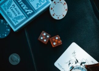 two orange dice on black surface