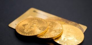 three round gold-colored Bitcoin tokens
