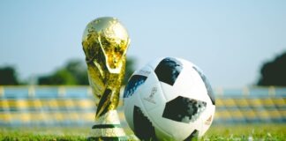 gold-colored trophy and soccerball