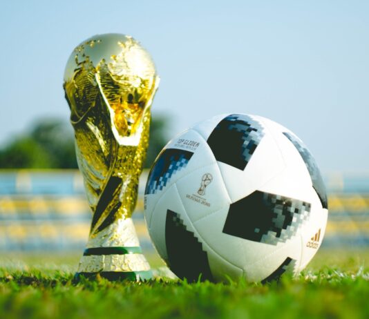 gold-colored trophy and soccerball