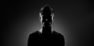 grayscale photography of man wearing black t-shirt