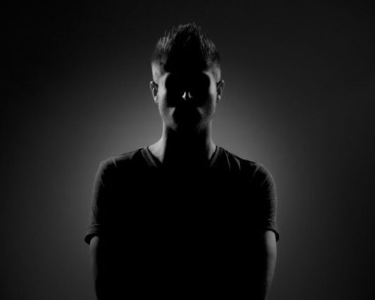 grayscale photography of man wearing black t-shirt