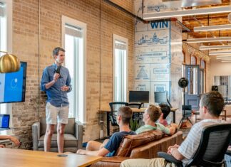 What impact does bitcoin have on the internet and business sector? man standing in front of group of men