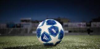 white blue soccer ball on green grass field during daytime