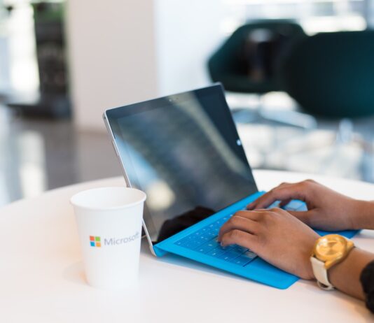 person using blue Microsoft Surface