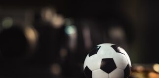white and black soccer ball on black sand