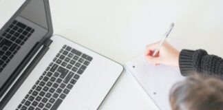 woman writing on notebook