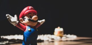 Super Mario figurine on brown surface