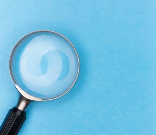 magnifying glass on white table