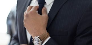 man wearing watch with black suit