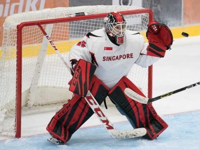 Photo by Eugene Lim hockey goalie showing defense pose during game