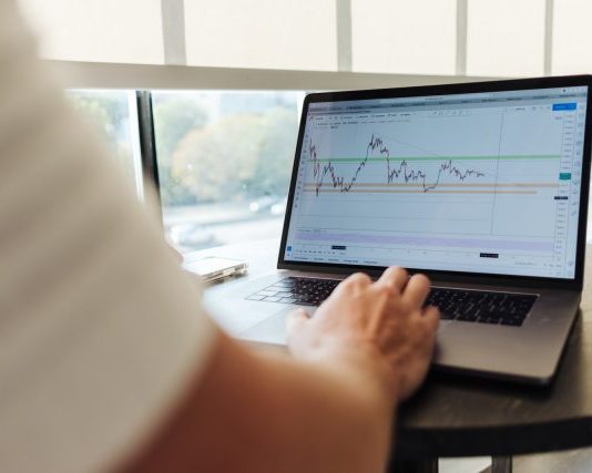 person using MacBook Pro on table