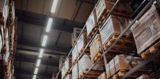 brown cardboard boxes on white metal rack