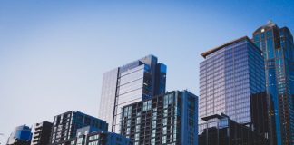 white and blue glass walled high rise building
