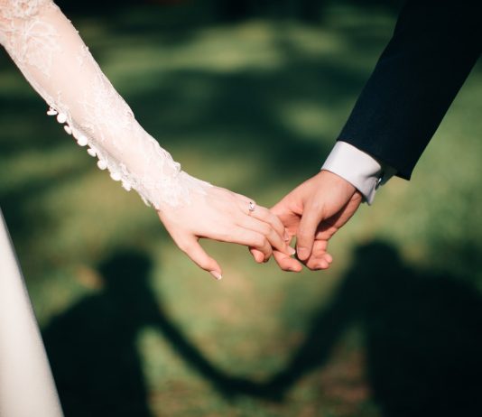 man and woman holding hands focus photo