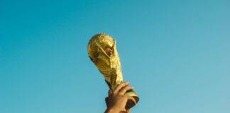 person holding gold trophy