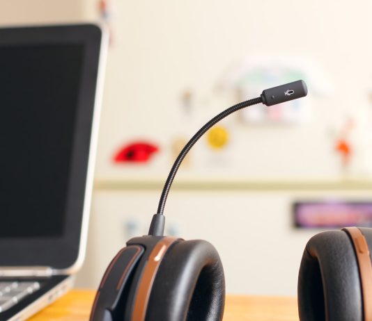 black and brown headset near laptop computer