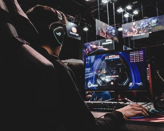 person sitting on gaming chair while playing video game