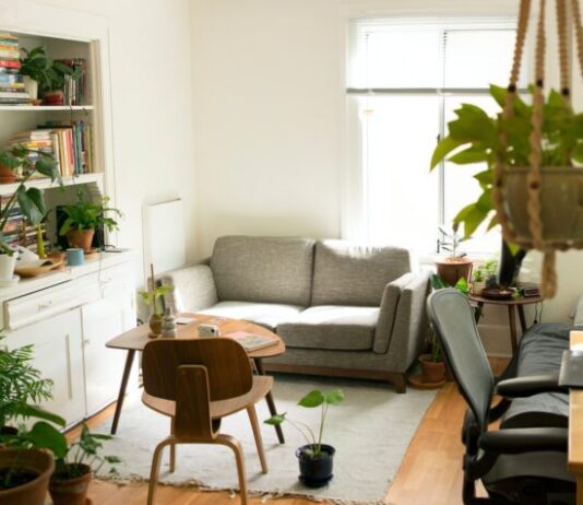 gray fabric loveseat near brown wooden table