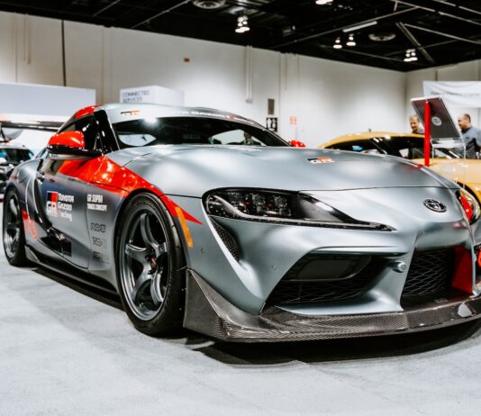 silver porsche 911 parked in a room