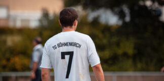 man in white and black crew neck t-shirt and black shorts