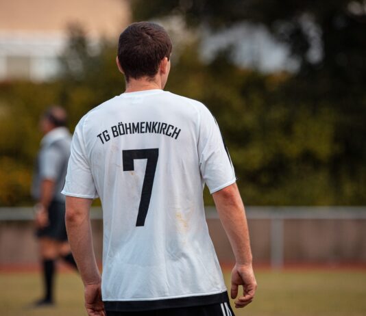 man in white and black crew neck t-shirt and black shorts