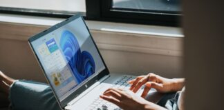 person using Windows 11 computer on lap