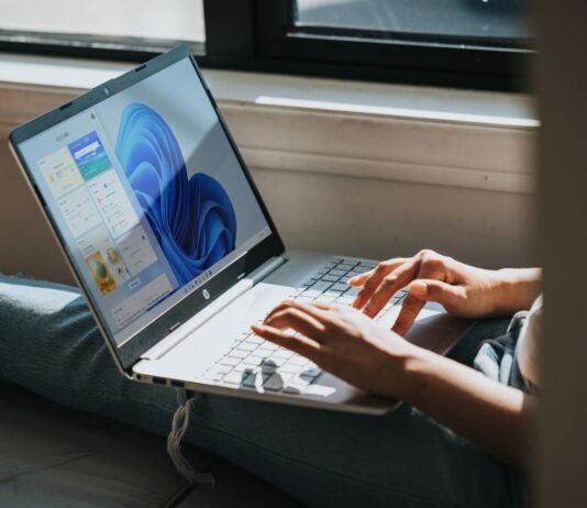 person using Windows 11 computer on lap