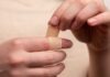 person with band aid on middle finger