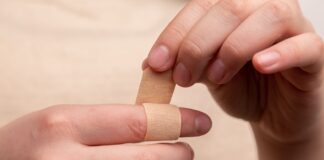 person with band aid on middle finger