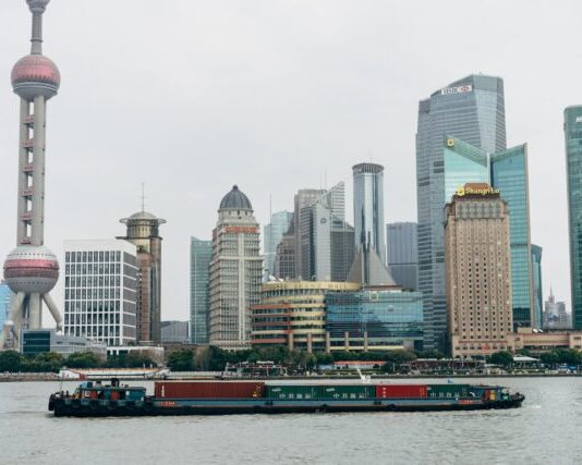 gray and red passenger boat on body of water