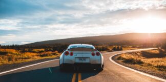 silver sports coupe on asphalt road