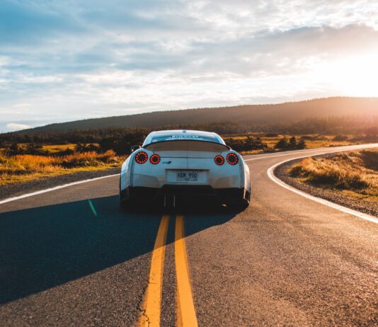 silver sports coupe on asphalt road