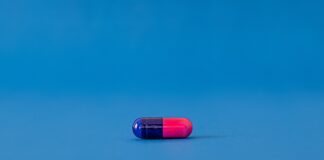 red and blue pill on blue surface