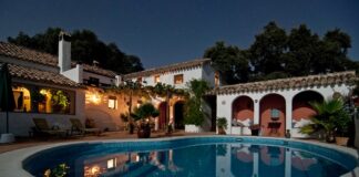 white concrete house surrounded by trees