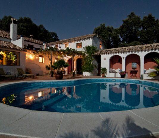 white concrete house surrounded by trees