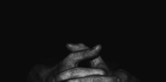 grayscale photo of persons hand