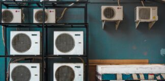 white and black box fan on brown wooden shelf