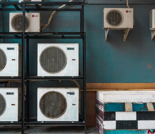 white and black box fan on brown wooden shelf