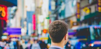 shallow focus photography of man in suit jacket's back