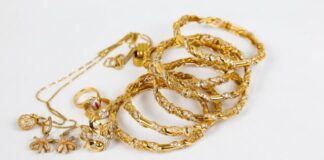 gold chain necklace on white surface