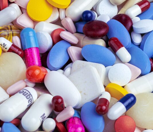 pílula de medicamentos branco azul e laranxa