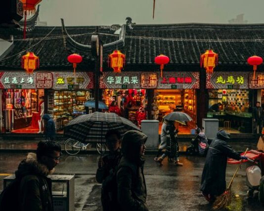 person carrying umbrellas