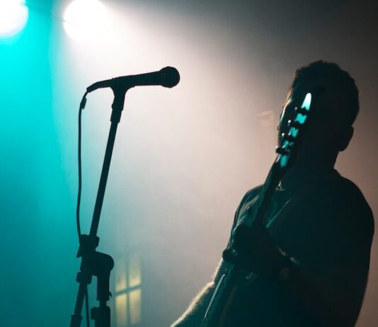 man holding electric guitar