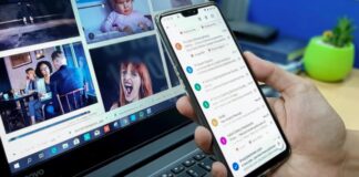 person using smartphone and laptop computer