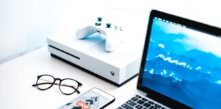 turned on MacBook Pro beside iPhone and Xbox One Slim