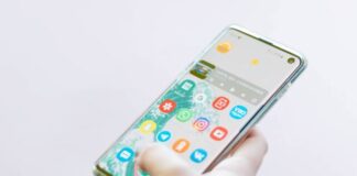 person using silver Android smartphone