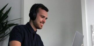 man in black polo shirt using laptop computer